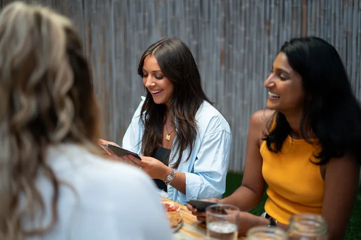 Women's dinner group laughing together